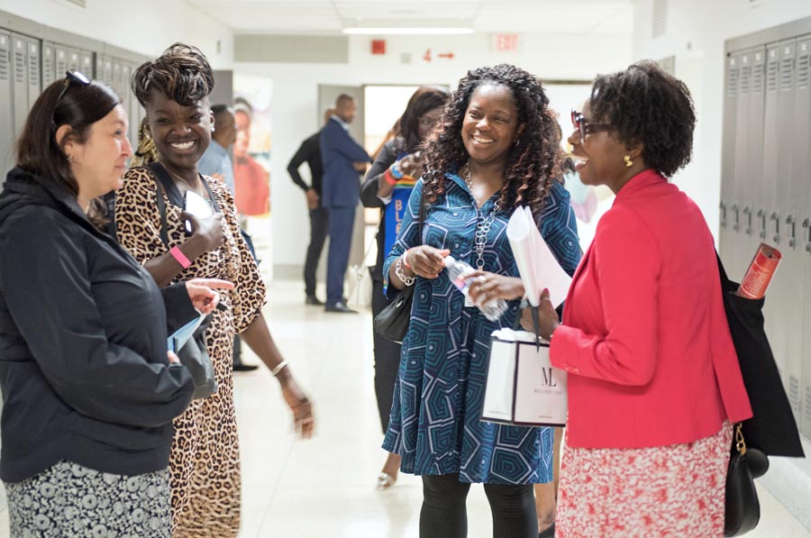 Guests are in the hallway smiling.  Open Gallery